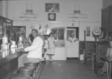 Patrons including an African American man dining inside a local eatery, Seattle, ca. 1950's