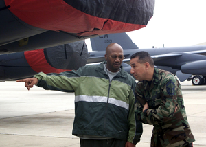 Recording artists Rodney Ellis, a member of the Rhythm and Blues music group "Kool and the Gang", asks US Air Force (USAF) SENIOR MASTER Sergeant (SMSGT) Edward Maldonado, 96 Bomb Squadron, a question about the USAF B-52 Stratofortress aircraft during the groups visit to Barksdale AFB, Louisiana (LA). Members of the group "Kool and the Gang" toured the base, signed autographs, and raffled off tickets to military personnel before their concert at a local casino that night
