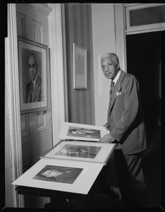 Addison N. Scurlock inspecting some of his portraits : acetate film photonegative and prints