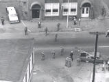 Aerial view of police gathered at unidentified intersection after riots, Rochester, NY, 1964