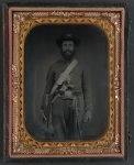 [Unidentified cavalry soldier in Union uniform with Sharps carbine rifle, Colt revolver, and cavalry saber]