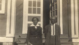 African American woman and man standing in front of a rural school building in Boykin, Alabama.