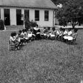 Nun teaching children on the lawn of Nazareth Catholic Mission in Montgomery, Alabama.