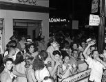 Crowd celebrating V-J Day on a street corner in downtown Birmingham, Alabama.